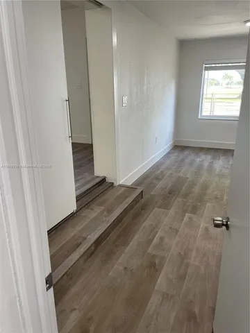 an empty room with wooden floor