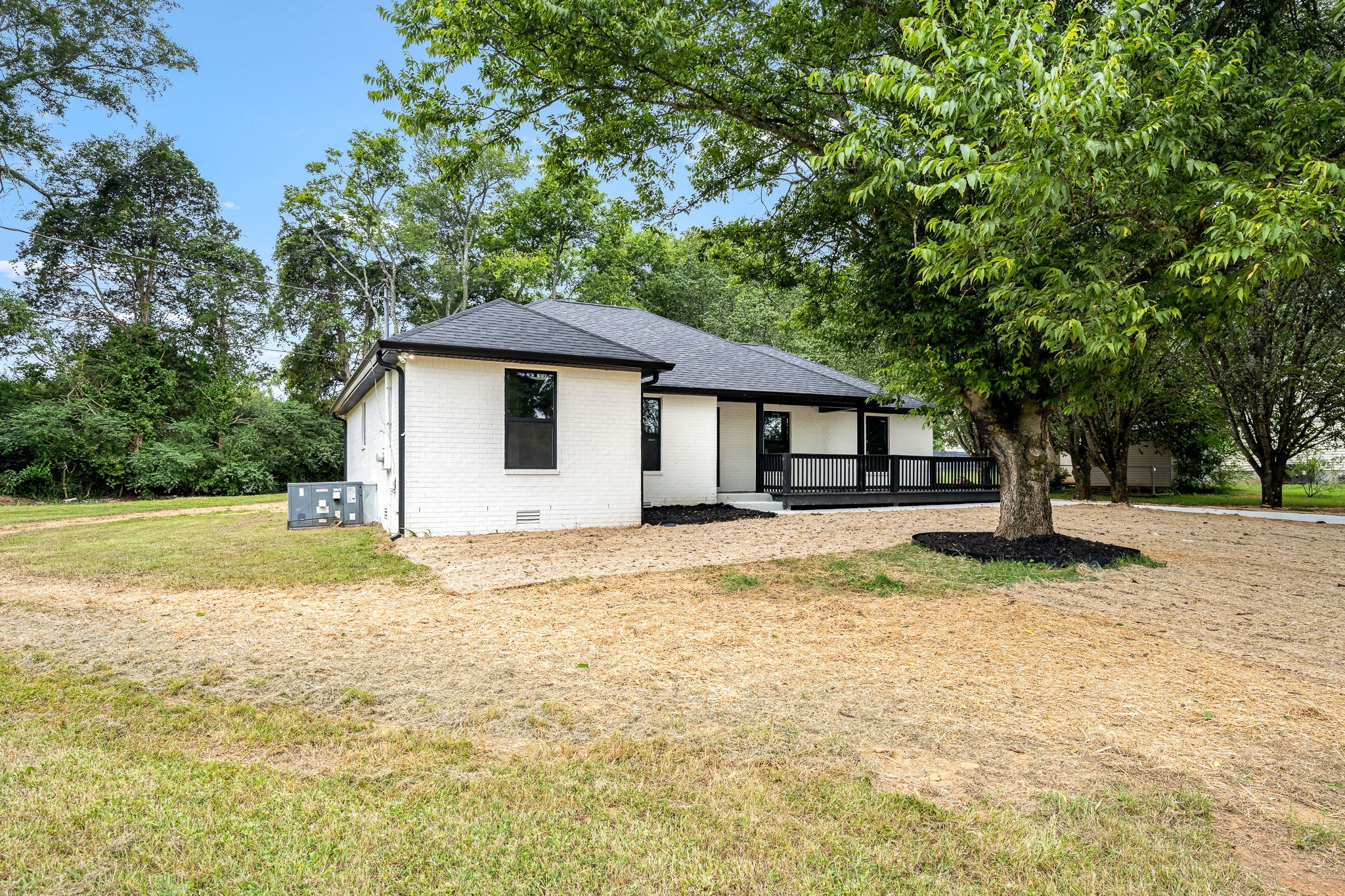 a front view of house with yard and trees