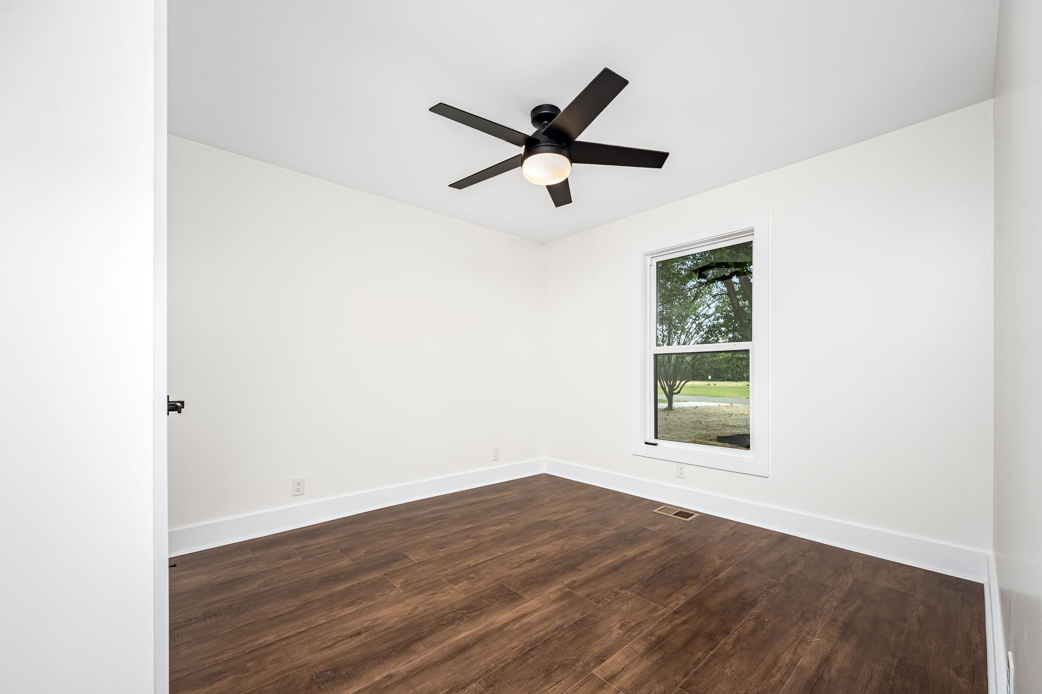 2712 Oak Point Street Murfreesboro, TN 37130 - Photo 27 of 45 an empty room with wooden floor and windows