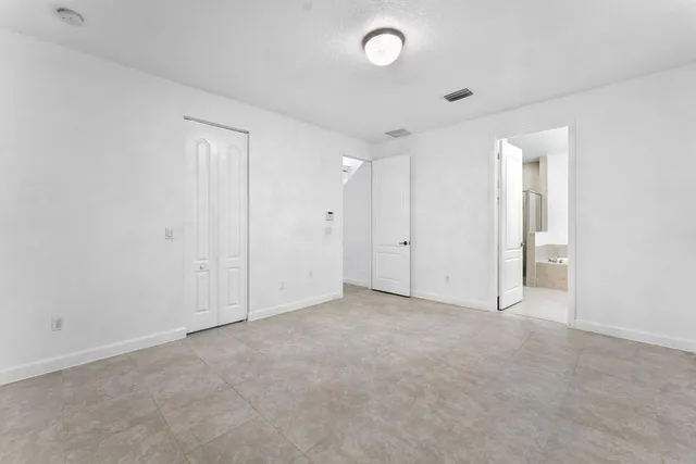 an empty room with closet area