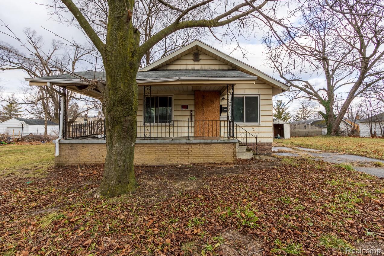 Bungalow-style home featuring a porch and roof with shingles