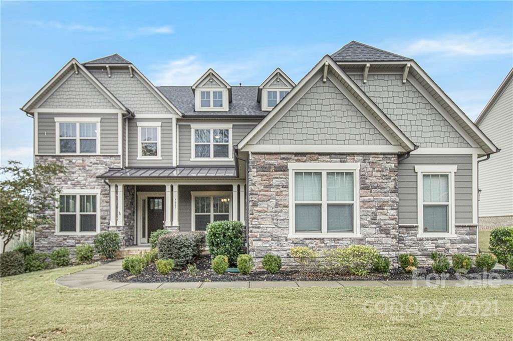 7007 Fallondale Road Waxhaw, NC 28173 - Photo 1 of 24 a front view of a house with a large window and potted plants