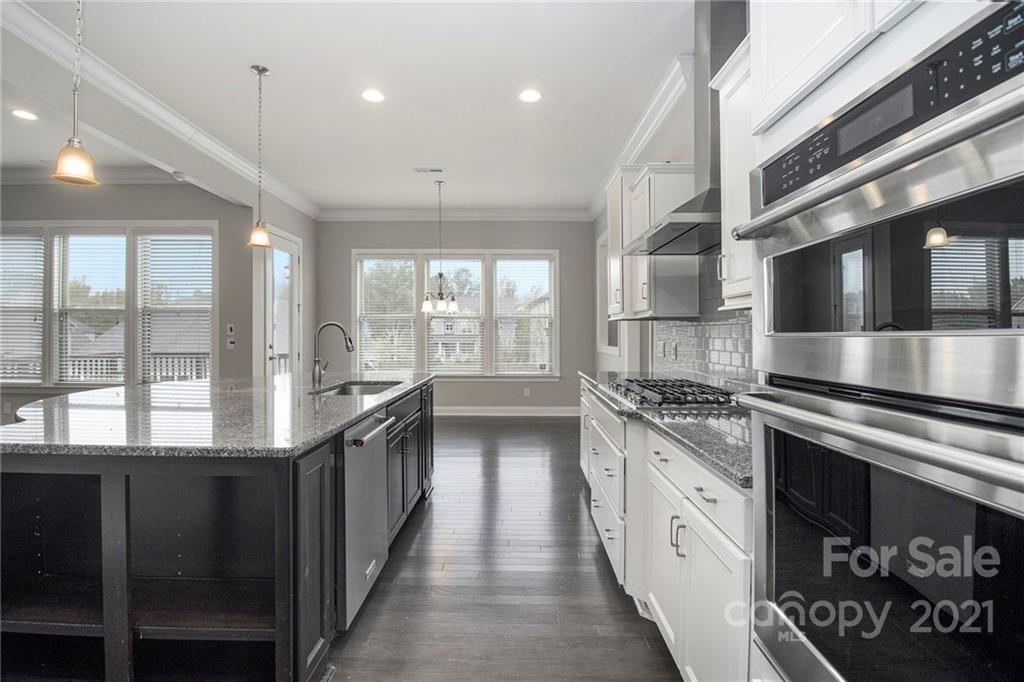 7007 Fallondale Road Waxhaw, NC 28173 - Photo 2 of 24 a kitchen with stainless steel appliances granite countertop a stove and a sink