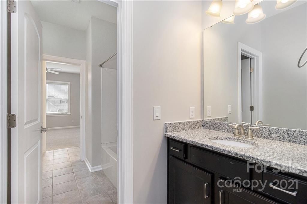 7007 Fallondale Road Waxhaw, NC 28173 - Photo 18 of 24 a bathroom with a granite countertop sink and a mirror