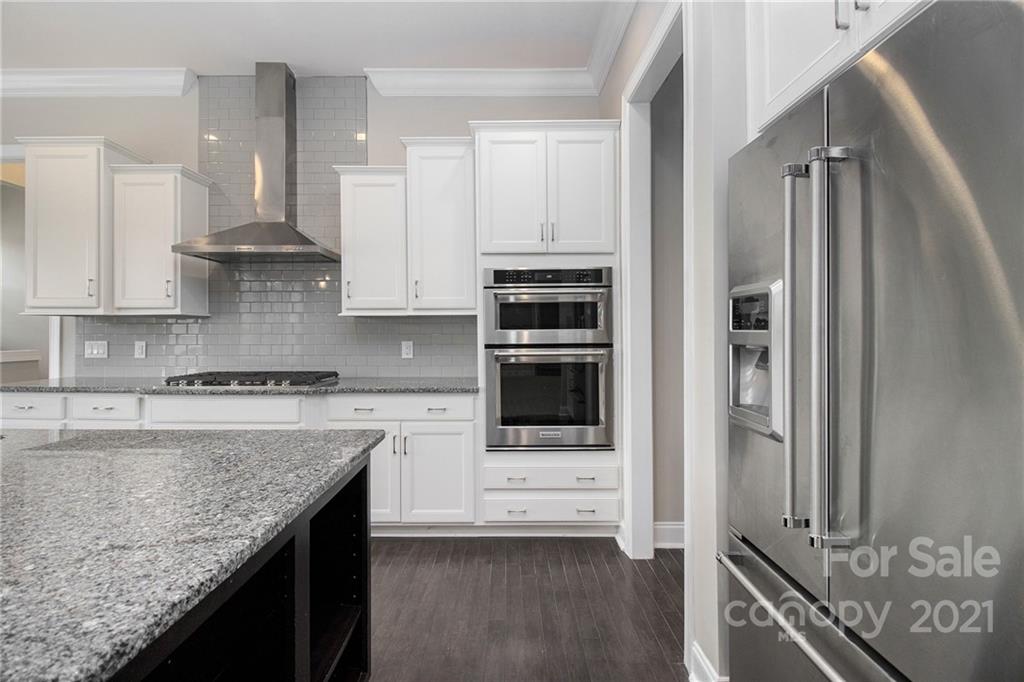 7007 Fallondale Road Waxhaw, NC 28173 - Photo 3 of 24 a kitchen with stainless steel appliances granite countertop a stove and a refrigerator