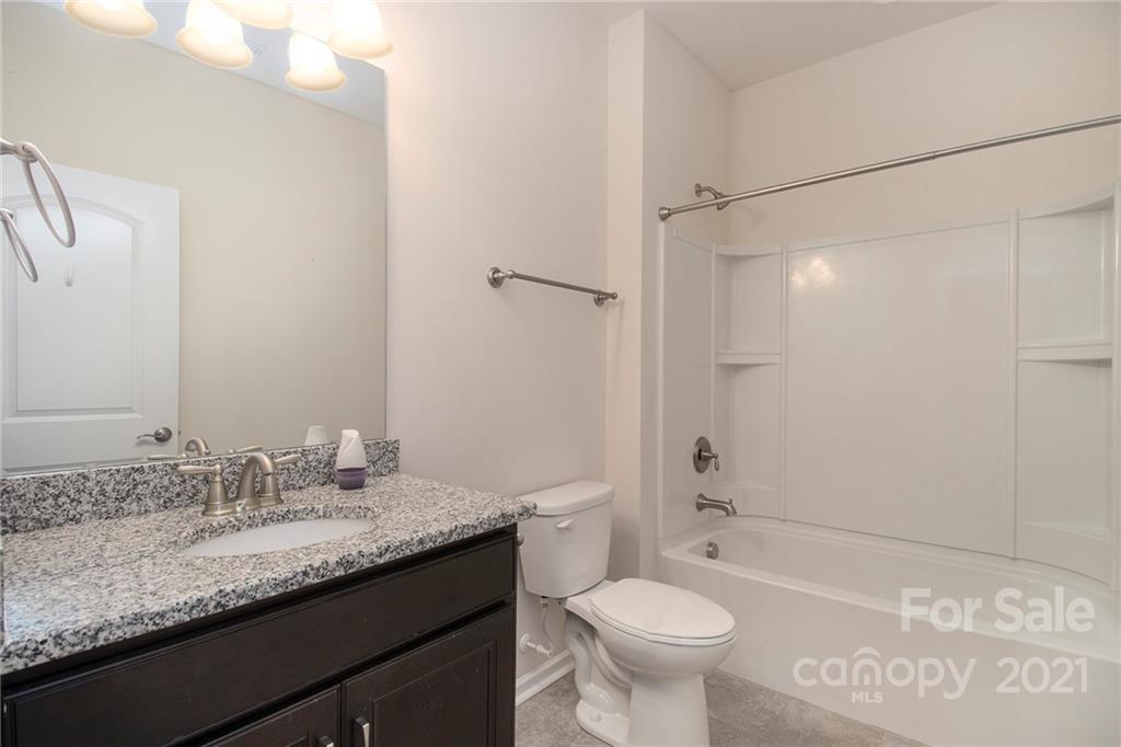 7007 Fallondale Road Waxhaw, NC 28173 - Photo 22 of 24 a bathroom with a granite countertop sink toilet and shower