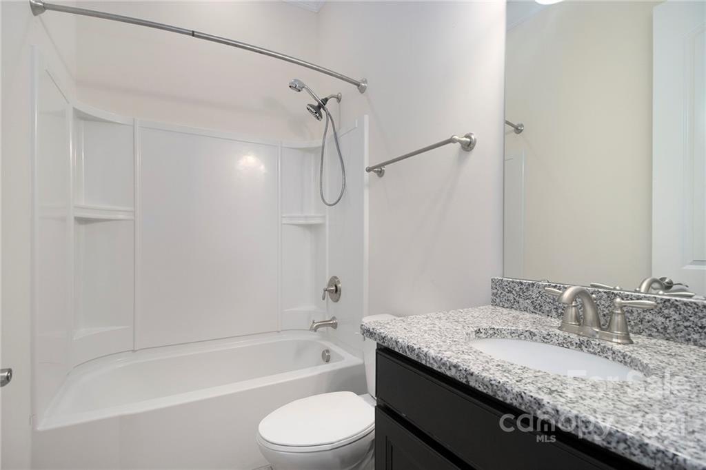 7007 Fallondale Road Waxhaw, NC 28173 - Photo 24 of 24 a bathroom with a granite countertop sink toilet and shower