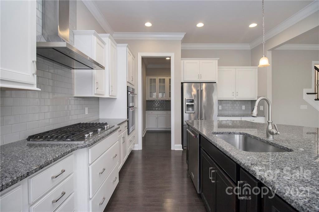 7007 Fallondale Road Waxhaw, NC 28173 - Photo 4 of 24 a kitchen with granite countertop a sink stove and refrigerator
