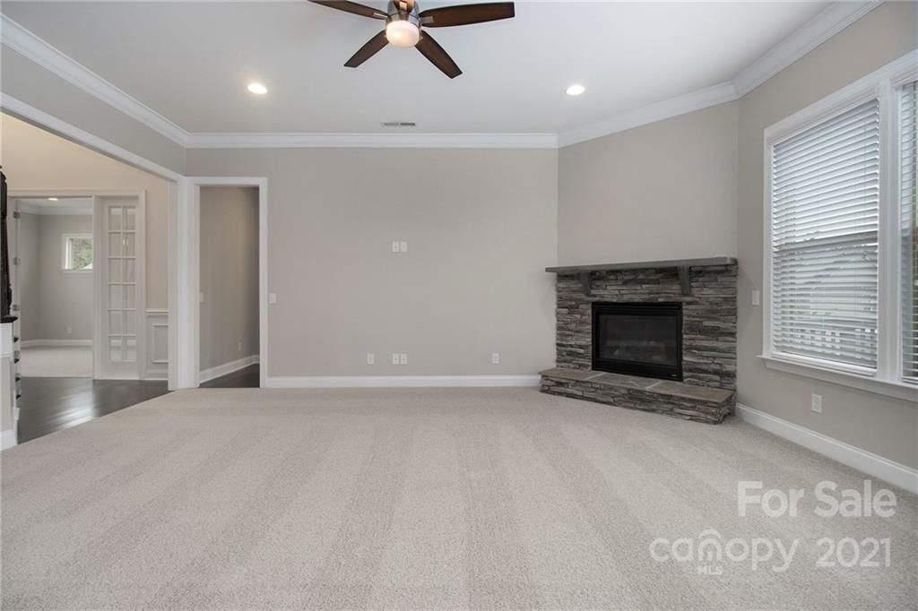7007 Fallondale Road Waxhaw, NC 28173 - Photo 6 of 24 an empty room with fireplace and windows