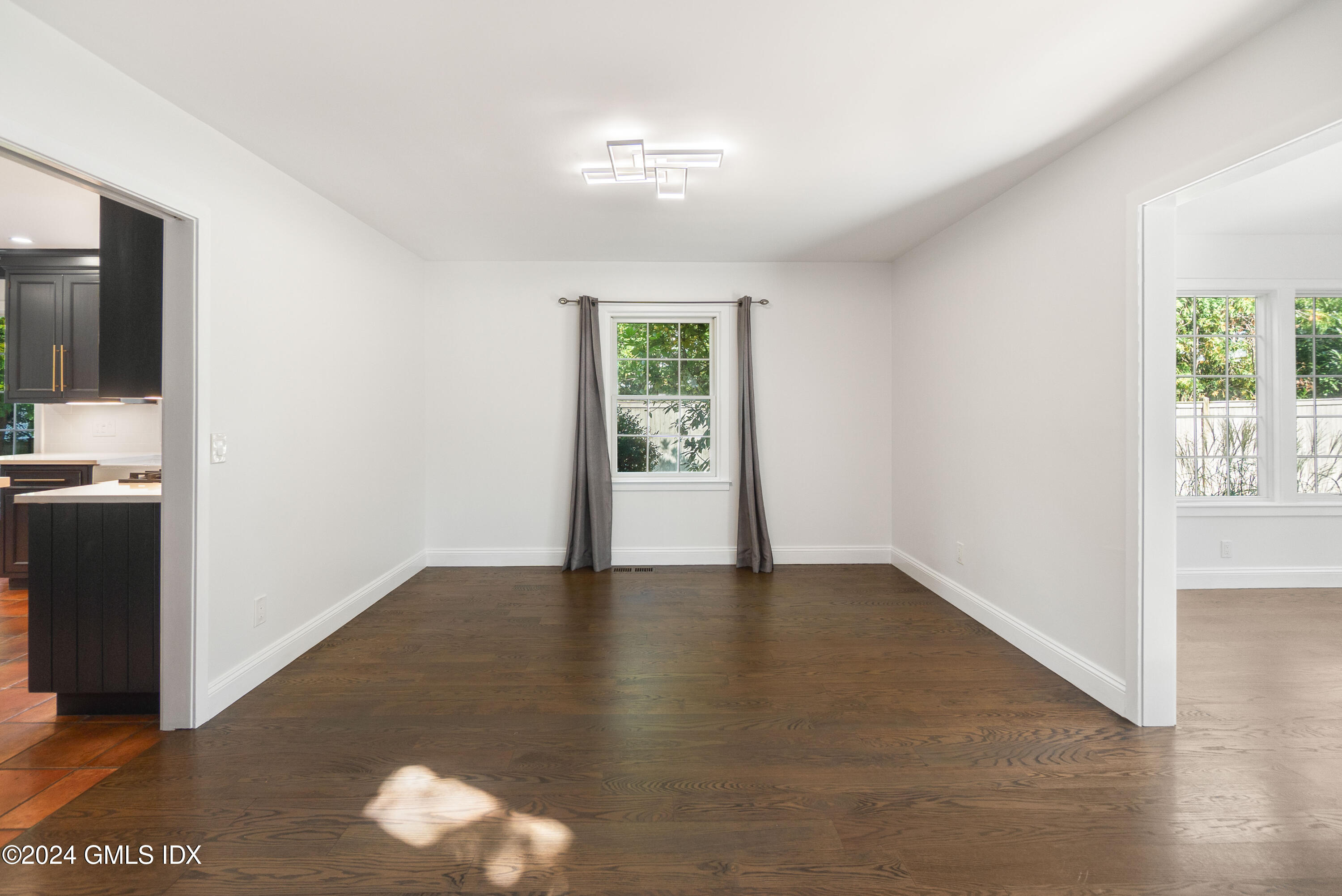 6 Hendrie Avenue Riverside, CT 06878 - Photo 14 of 44 a view of an empty room with wooden floor and a window
