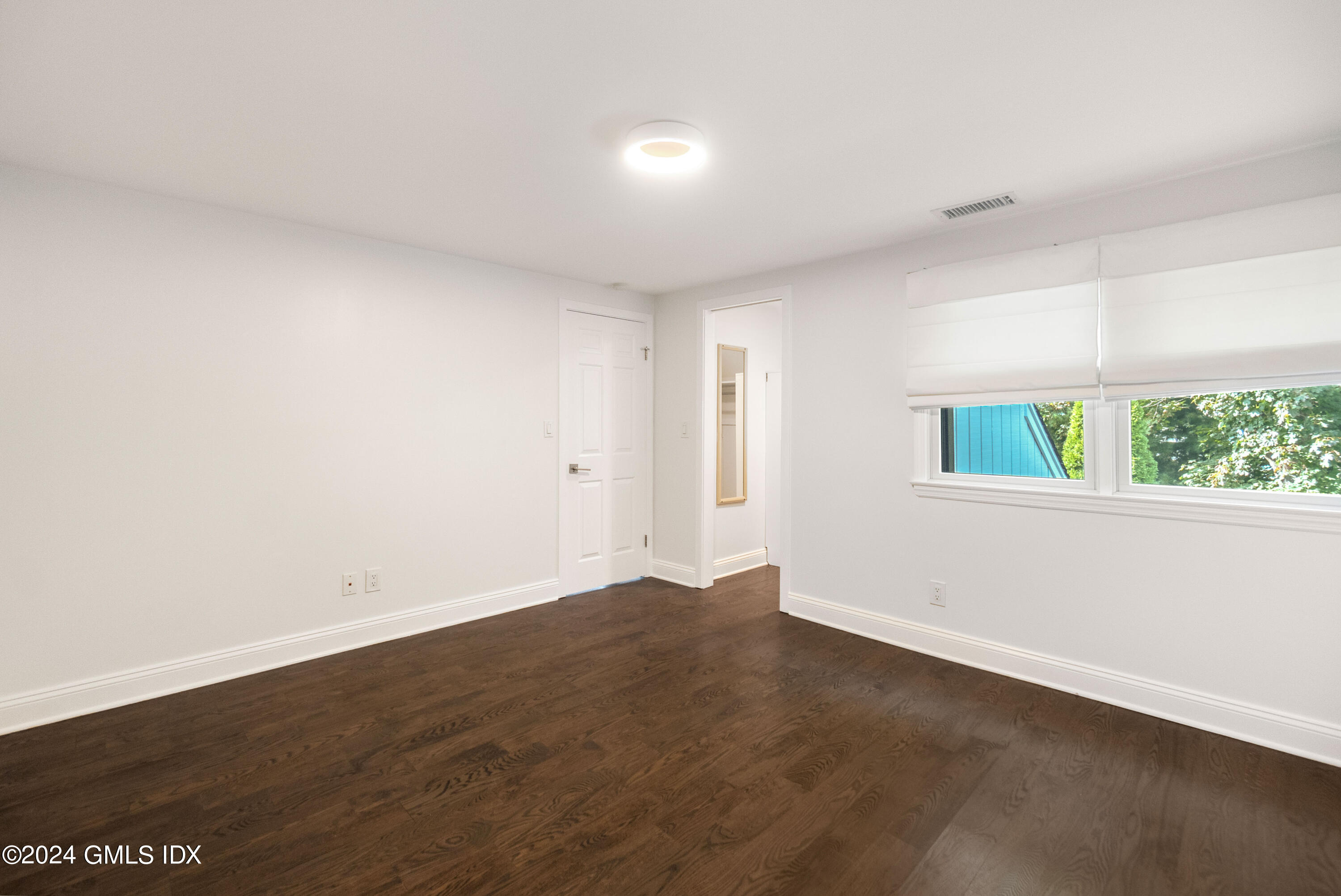 6 Hendrie Avenue Riverside, CT 06878 - Photo 26 of 44 an empty room with wooden floor and windows
