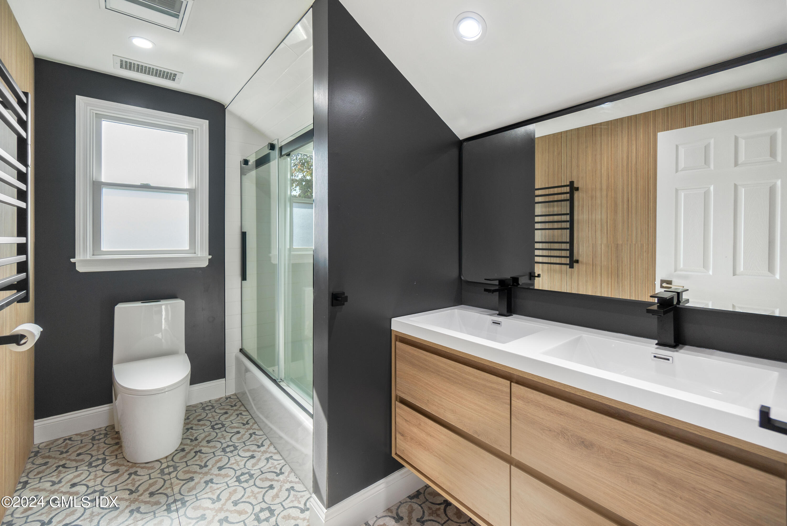 6 Hendrie Avenue Riverside, CT 06878 - Photo 27 of 44 a bathroom with a granite countertop sink toilet a mirror and a tub