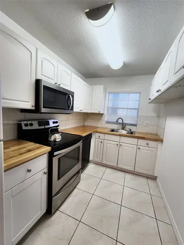 a kitchen with stainless steel appliances and white cabinets