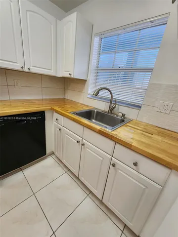 a kitchen with cabinets appliances and a sink