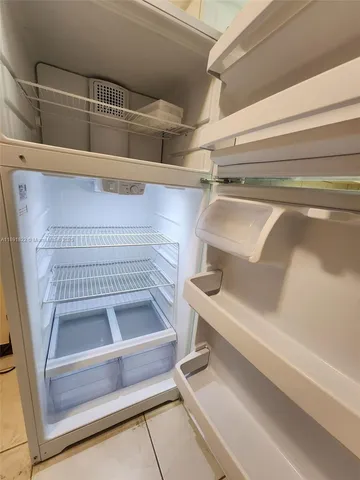 a view of walk in closet with racks on the wall