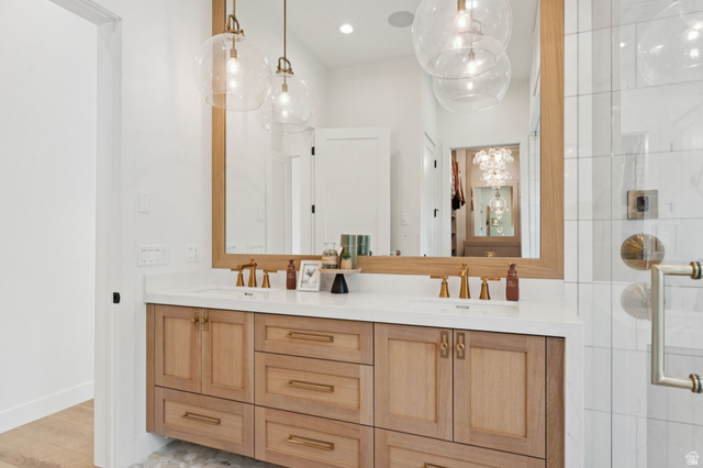 1400 Weber Wild Road Oakley, UT 84055 - Photo 32 of 55 Double vanity featuring wood-finish cabinetry, white countertop, and brass fixtures