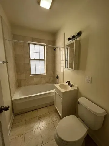 a bathroom with a sink a toilet and bathtub