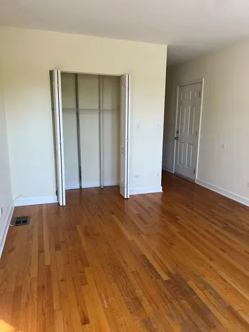 a view of an empty room and wooden floor
