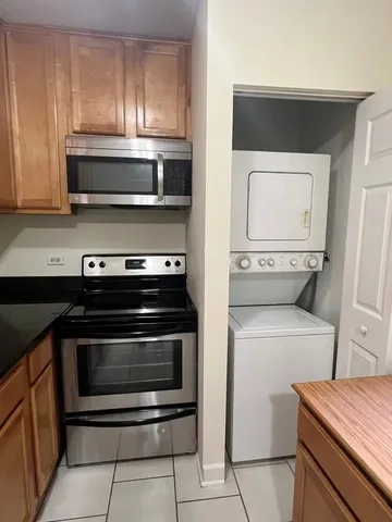 a kitchen with a stove and a microwave