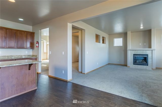 a view of a kitchen with a sink and a refrigerator