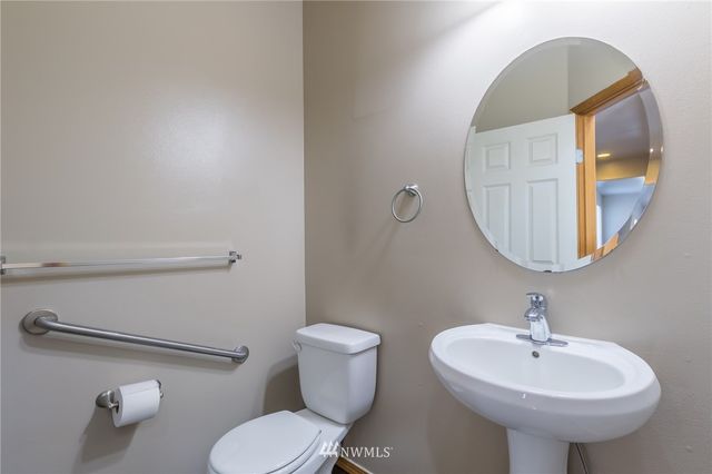 a bathroom with a sink toilet and mirror