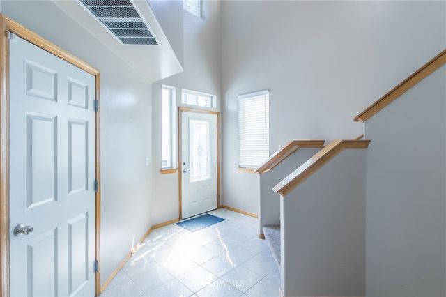 a view of entryway with wooden floor and stairs