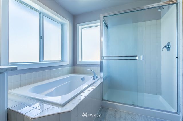 a bathroom with a tub and a shower