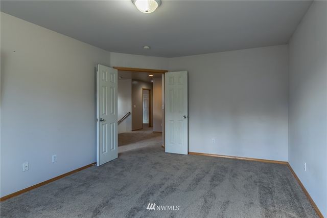 a view of an empty room and closet