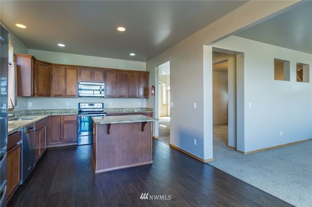 a kitchen with stainless steel appliances granite countertop refrigerator sink and cabinets