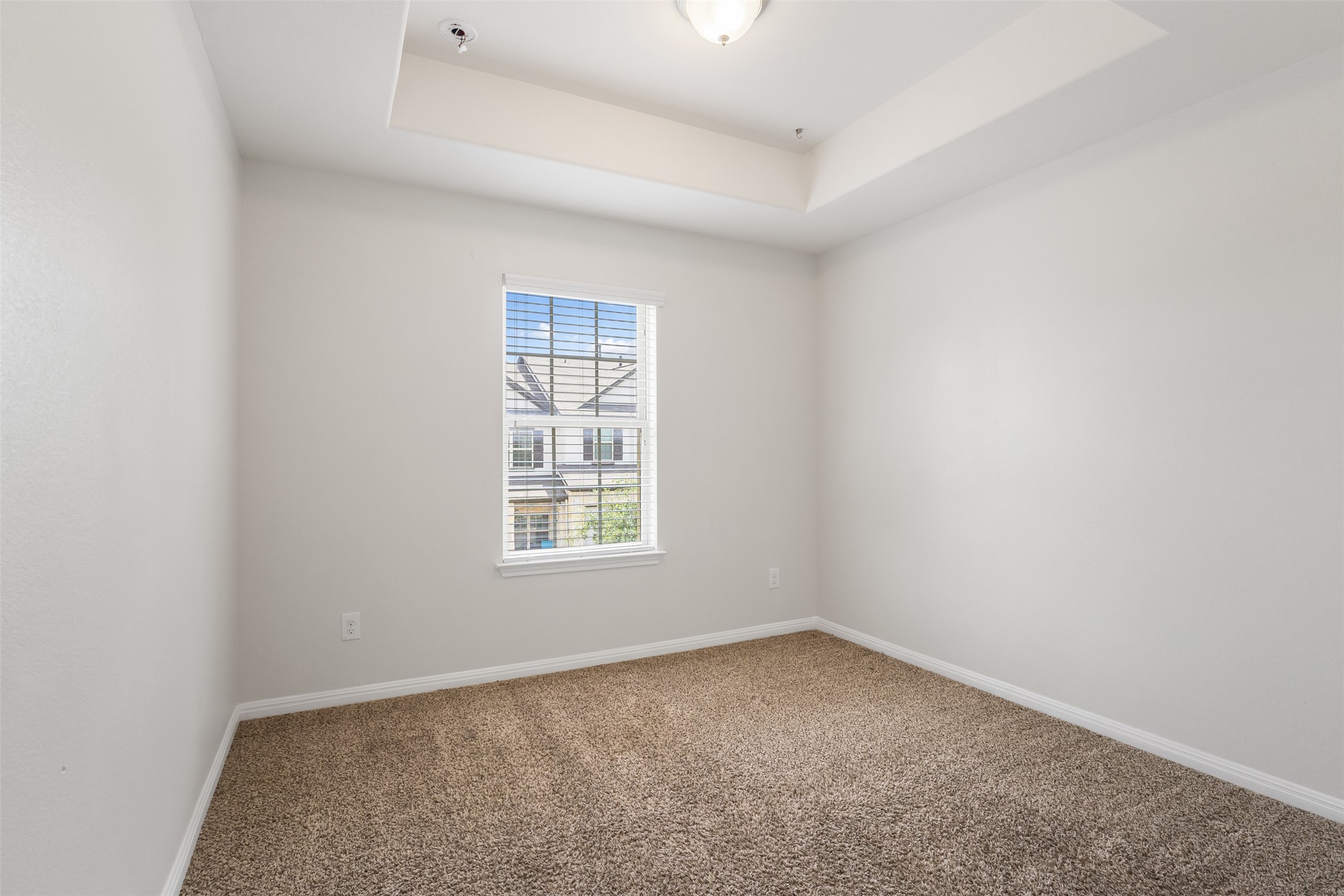 1510 Catalan Road, Unit 602 Austin, TX 78748 - Photo 25 of 36 Carpeted spare room with a tray ceiling and a pendent fire sprinkler
