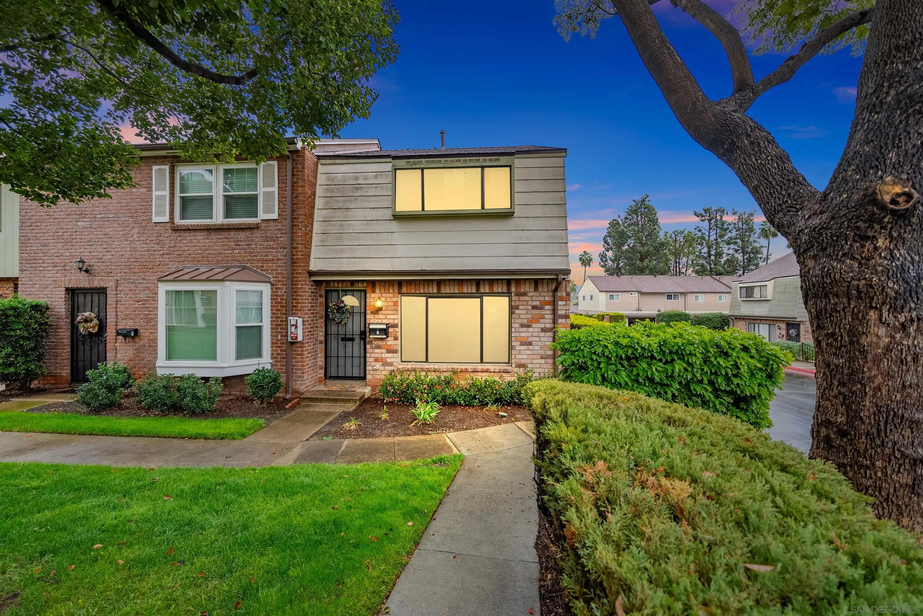 11911 Royal Road, Unit G El Cajon, CA 92021 - Photo 1 of 31 a front view of a house with a yard and outdoor seating