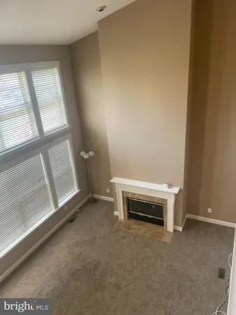 an empty room with windows and chandelier