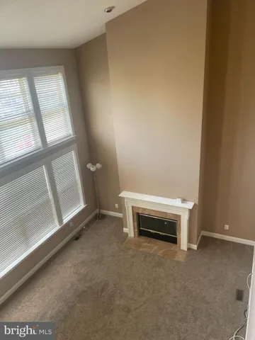 an empty room with windows and chandelier