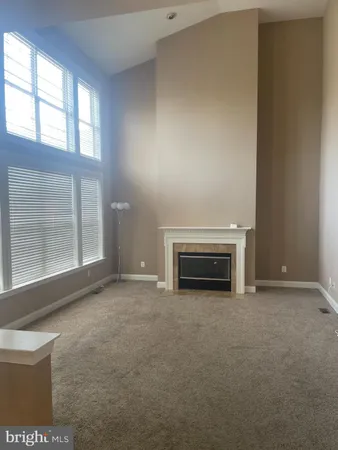 a view of empty room with a fireplace