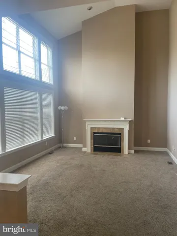 a view of empty room with a fireplace