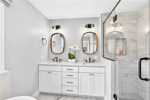 a bathroom with a double vanity sink and a mirror