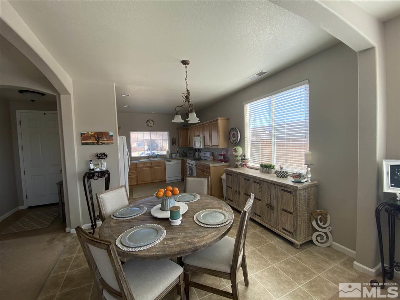1790 Ornellaia Way Reno, NV 89521 - Photo 3 of 22 a view of a dining room and livingroom with furniture wooden floor kitchen view and a chandelier