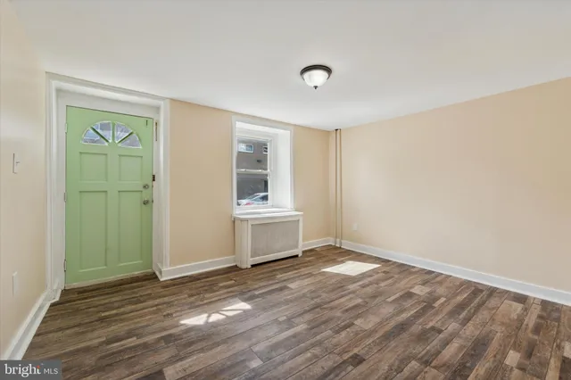 a view of a room with wooden floor and window
