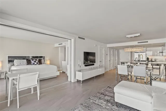 a living room with furniture flat screen tv and white walls