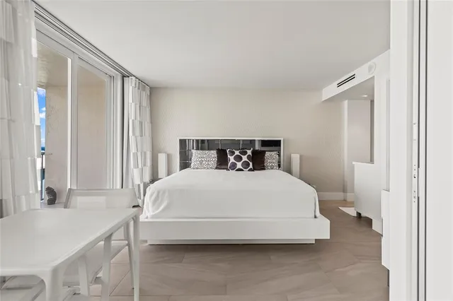 a bedroom with a bed and a table