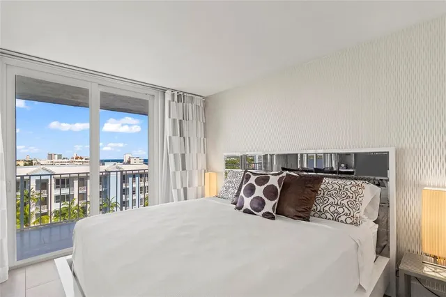 a bedroom with a large bed and a large window