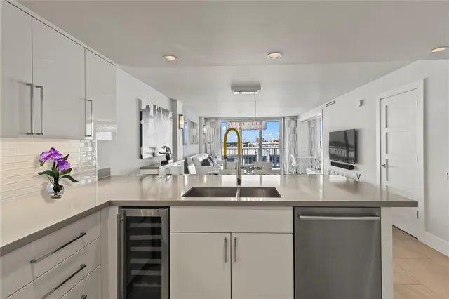 a kitchen with granite countertop a sink and cabinets