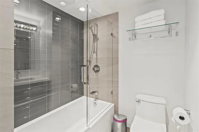 a bathroom with a bathtub shower vanity and toilet