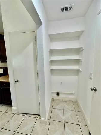 a view of a room with white cabinets
