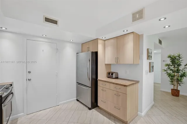 a kitchen with a sink and stainless steel appliances