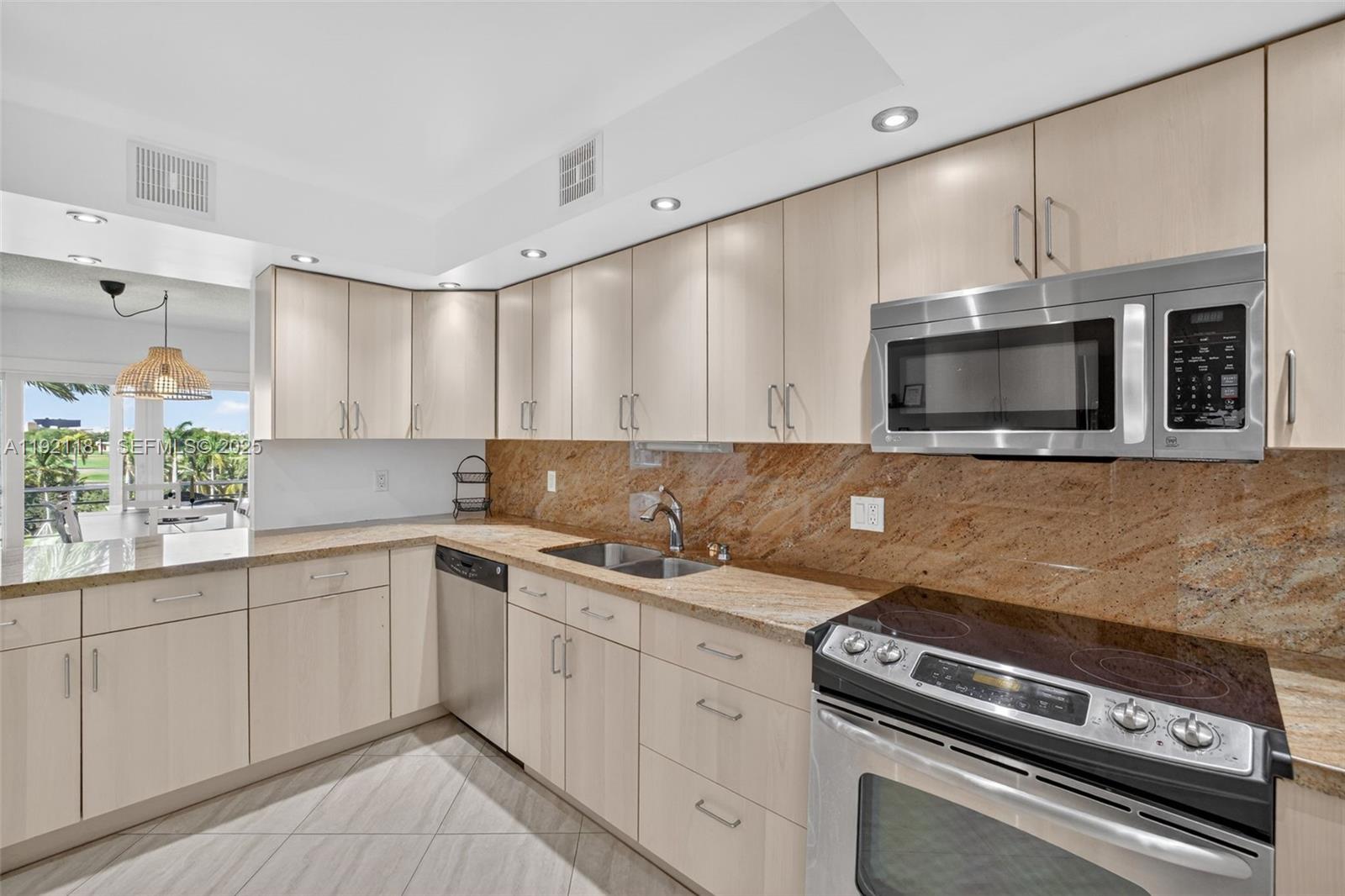 200 Diplomat Parkway, Unit 531 Hallandale Beach, FL 33009 - Photo 14 of 45 a kitchen with a sink and stainless steel appliances