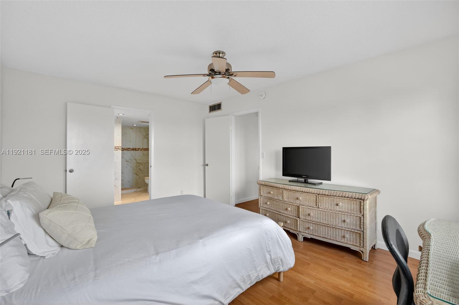 200 Diplomat Parkway, Unit 531 Hallandale Beach, FL 33009 - Photo 20 of 45 a bedroom with furniture a bed and a flat screen tv