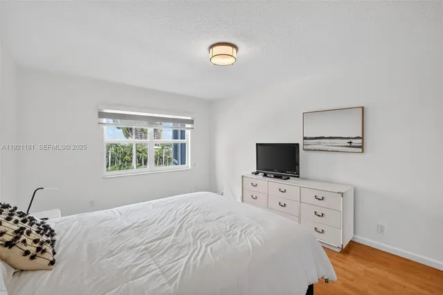 a bedroom with a bed and a television