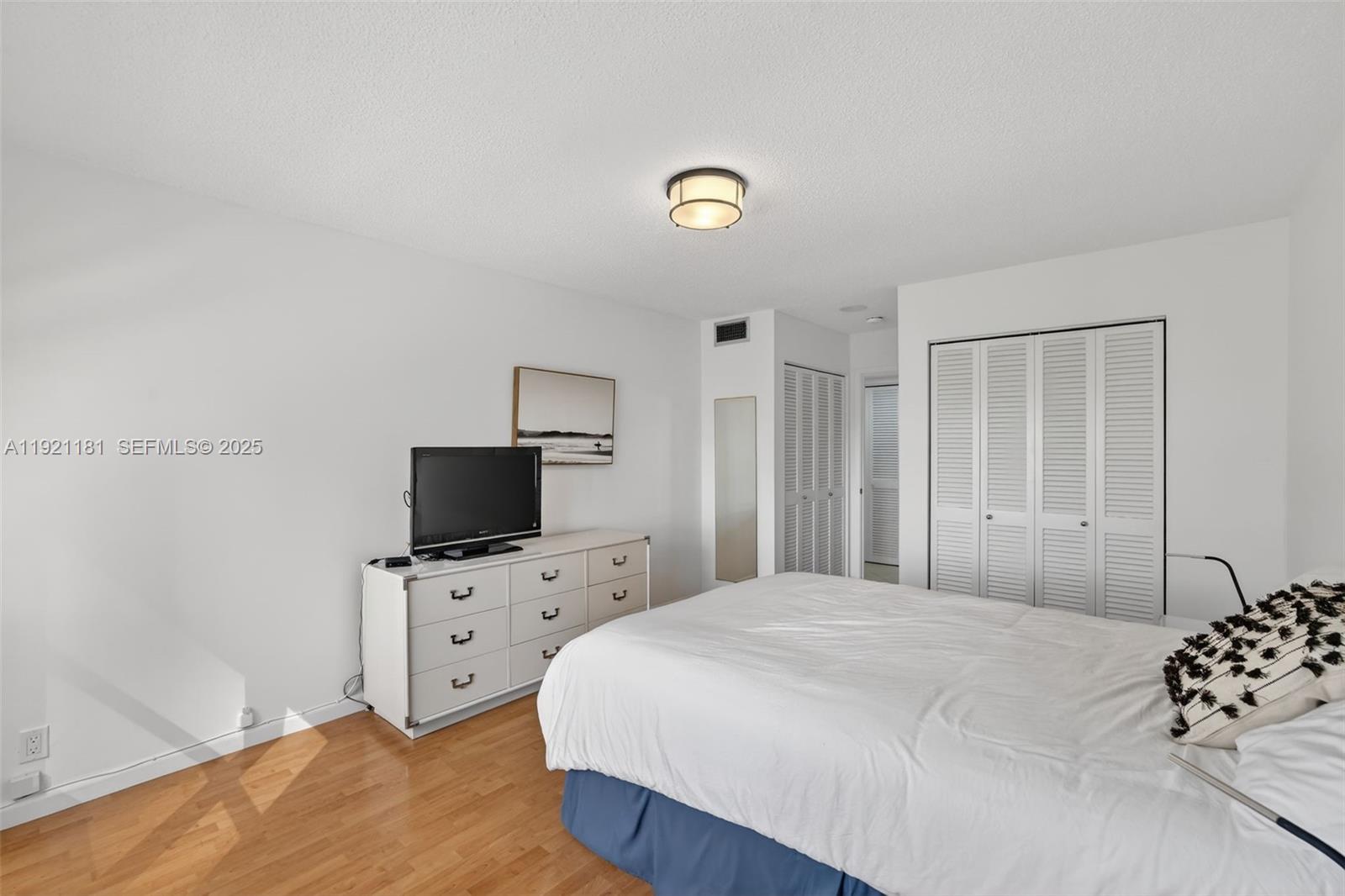 200 Diplomat Parkway, Unit 531 Hallandale Beach, FL 33009 - Photo 26 of 45 a bedroom with a bed and a television