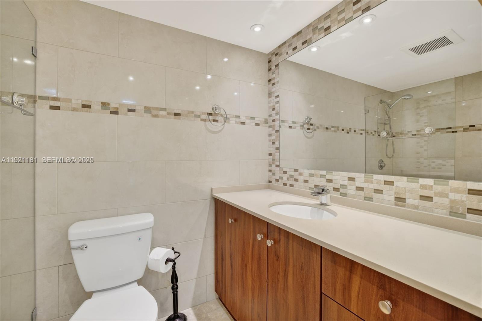 200 Diplomat Parkway, Unit 531 Hallandale Beach, FL 33009 - Photo 27 of 45 a bathroom with a sink toilet and shower